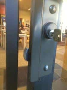 aluminum store front latch guard showing bolt protection